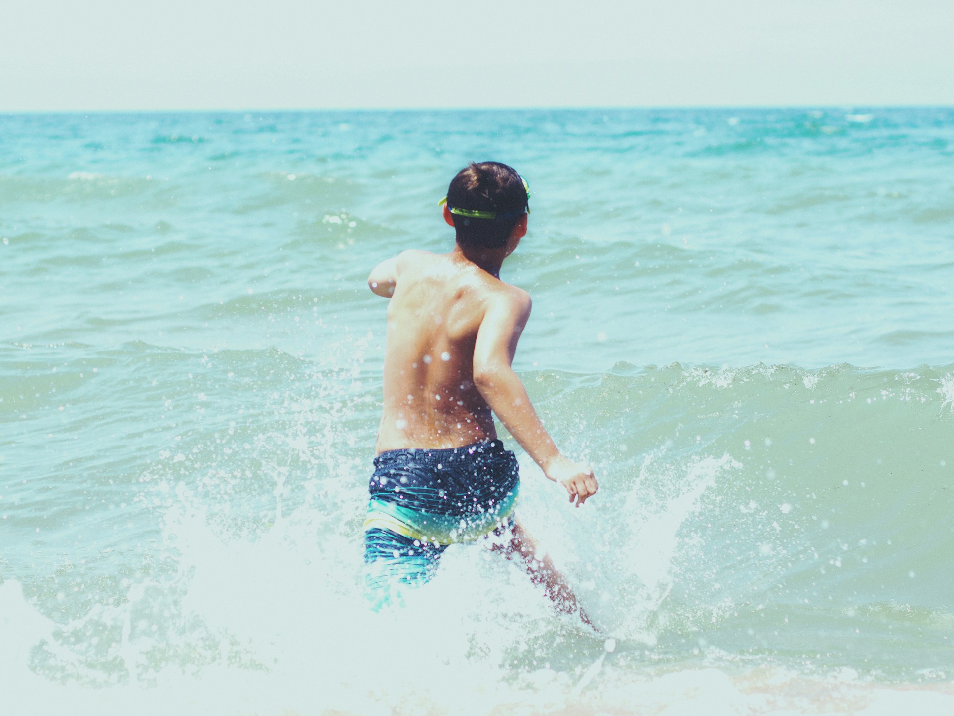 kid playing in lake michigan in grand haven