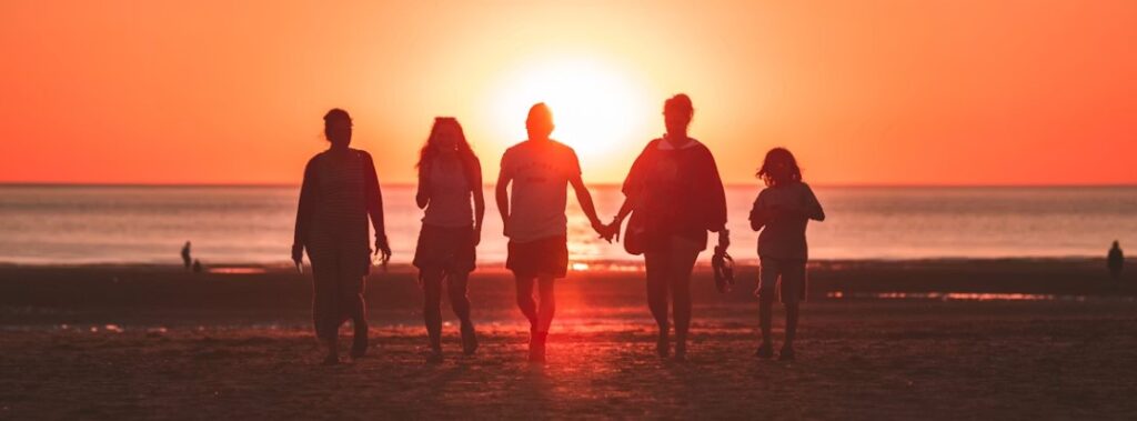 family on the beach at sunset in grand haven mi